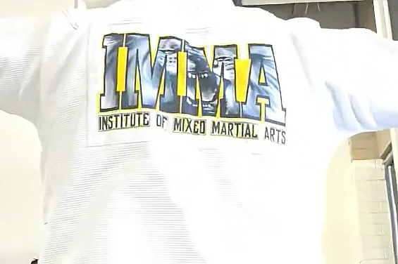 White Gimakx BJJ Gi with custom IMMA Institute of Mixed Martial Arts back print in yellow and grey