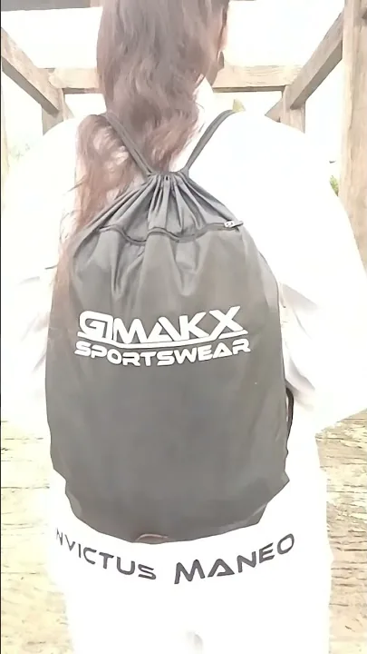 Custom white Gimakx BJJ Gi with an Invictus Maneo back print, worn with a branded Gimakx Sportswear drawstring gear bag
